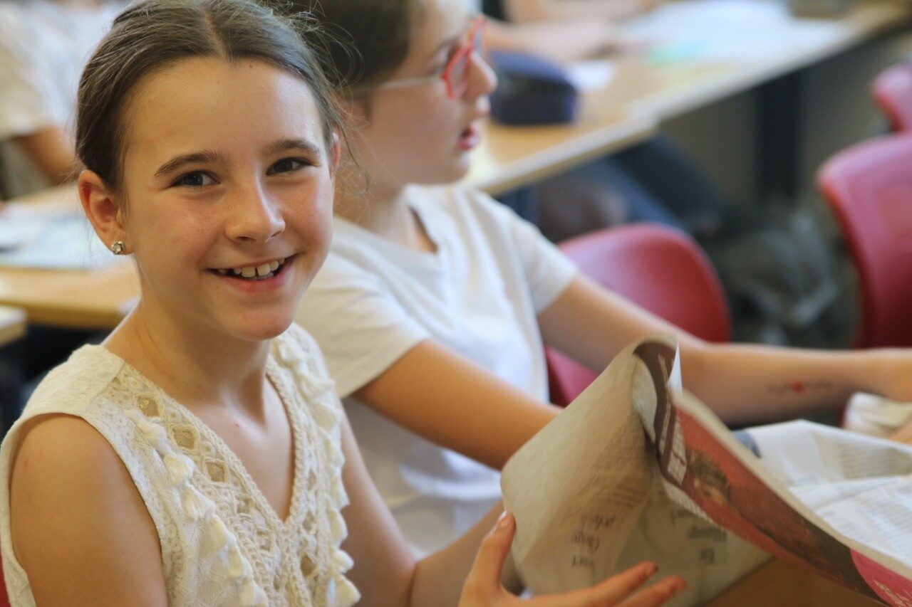 Schüler im Musikunterricht formen Zeitungspapier für ein Projekt der Neuen Musik